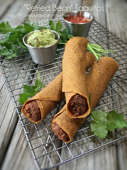 raw vegan “Refried Bean" Taquitos displayed on a wire rack