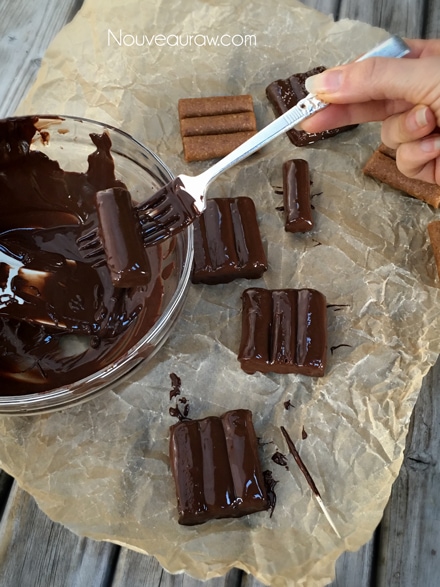 dipping Raw vegan Gluten-Free Salted Honey Nougat Candy Bars in chocolate