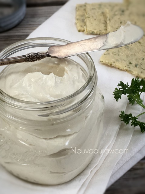 a close up of raw vegan Cultured Cashew Cream Cheese Spread in a mason jar