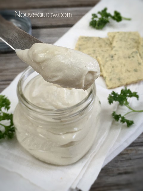 a close up on a knife of raw vegan Cultured Cashew Cream Cheese