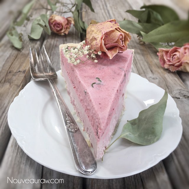 a gorgeous pale pink slice of Cultured Strawberry Mint Cheesecake with dried roses on top