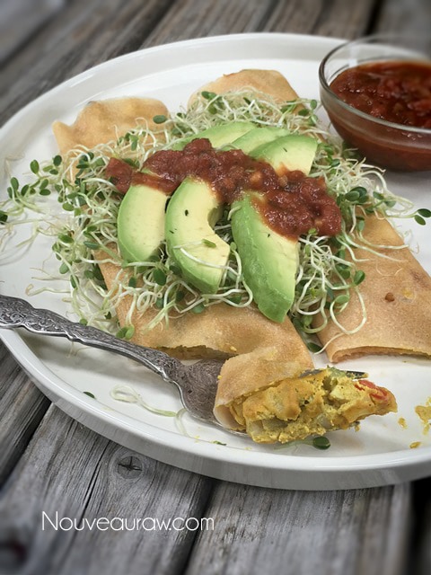 A yummy forkful of Morning Glory 'Egg'Salad Burito with fresh avocados and sprouts on top