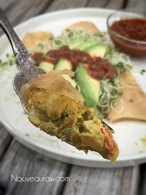 An amazing forkful of Morning Glory 'Egg'Salad Burito with fresh avocados and sprouts on top