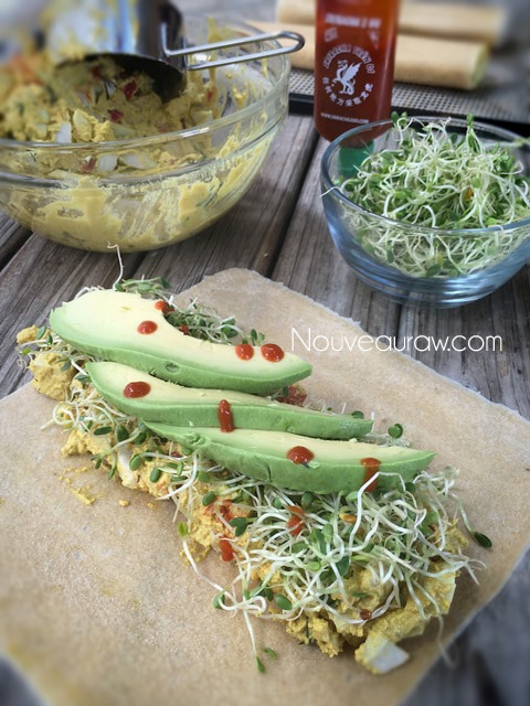 Rolling the delicious raw vegan Burrito with fresh veggies