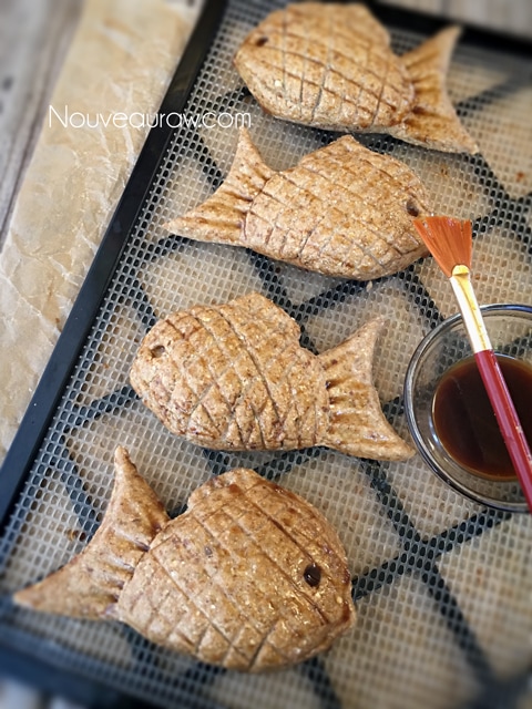 brushing them with a glaze to darken the raw vegan gluten-free Taiyaki Japanese Fish-Shaped Cakes