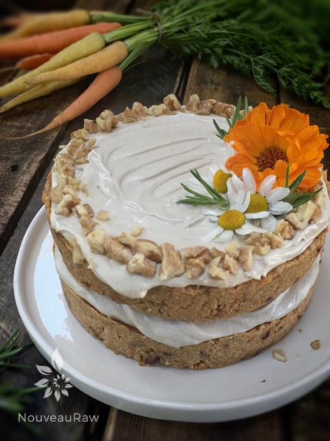 Edible flowers make for wonderful decor on the raw vegan gluten-free Rosemary Cranberry Carrot Cake 