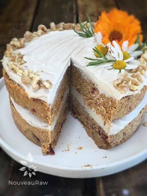  raw vegan gluten-free Rosemary Cranberry Carrot Cake displayed on a barn wood