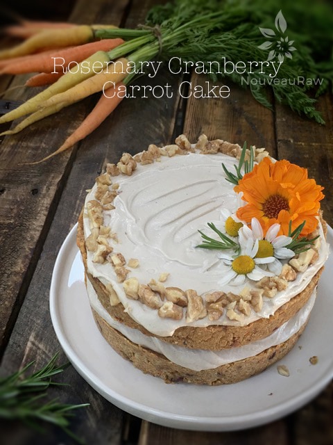 raw vegan gluten-free Rosemary Cranberry Carrot Cake wth fresh flowers on top
