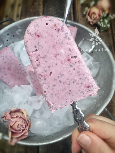 a close up of raw vegan Strawberry Rhubarb Coconut Chia Popsicles with old spoons for the handles