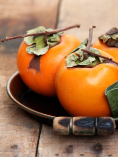 persimmons on a wooden table