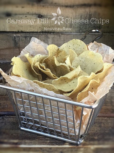 raw vegan Caraway and Dill Cheese Chips displayed in a wire basket