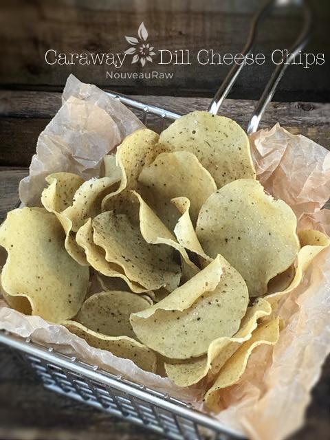 an over view of raw vegan Caraway and Dill Cheese Chips displayed in a wire basket