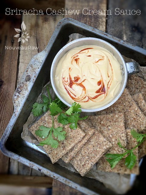 Sriracha Cashew Cream Sauce served in an old baking pan with crackers