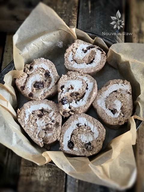 Line a pan with parchment paper and arrange the cinnamon rolls within.