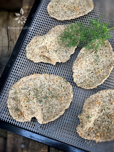 over photo of raw vegan gluten-free Caraway and Dill Crispy Flatbread on a dehydrator tray