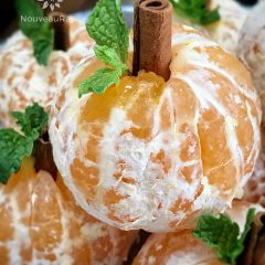 close up of Spooktacular Orange Fruit Pumpkins displayed on a silver tray for Halloween