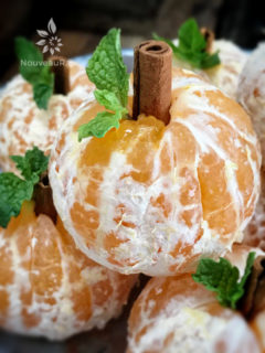 close up of Spooktacular Orange Fruit Pumpkins displayed on a silver tray for Halloween