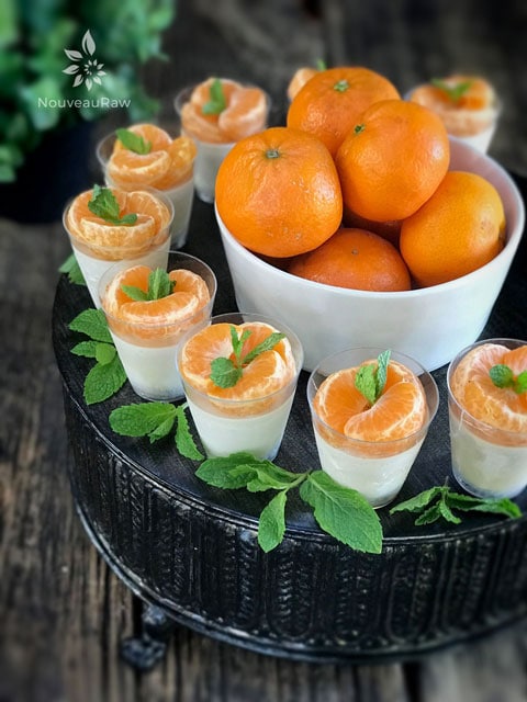 Orange Cream Party Cheesecakes served with fresh oranges